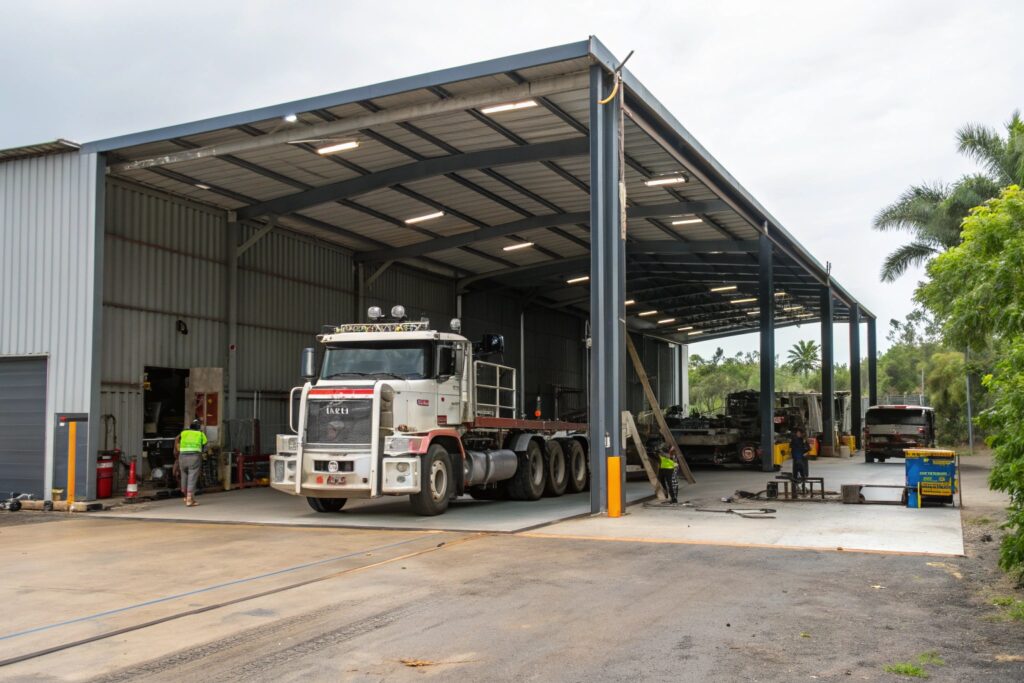 Industrial carport workspace with a truck maintenance bay in Mount Louisa