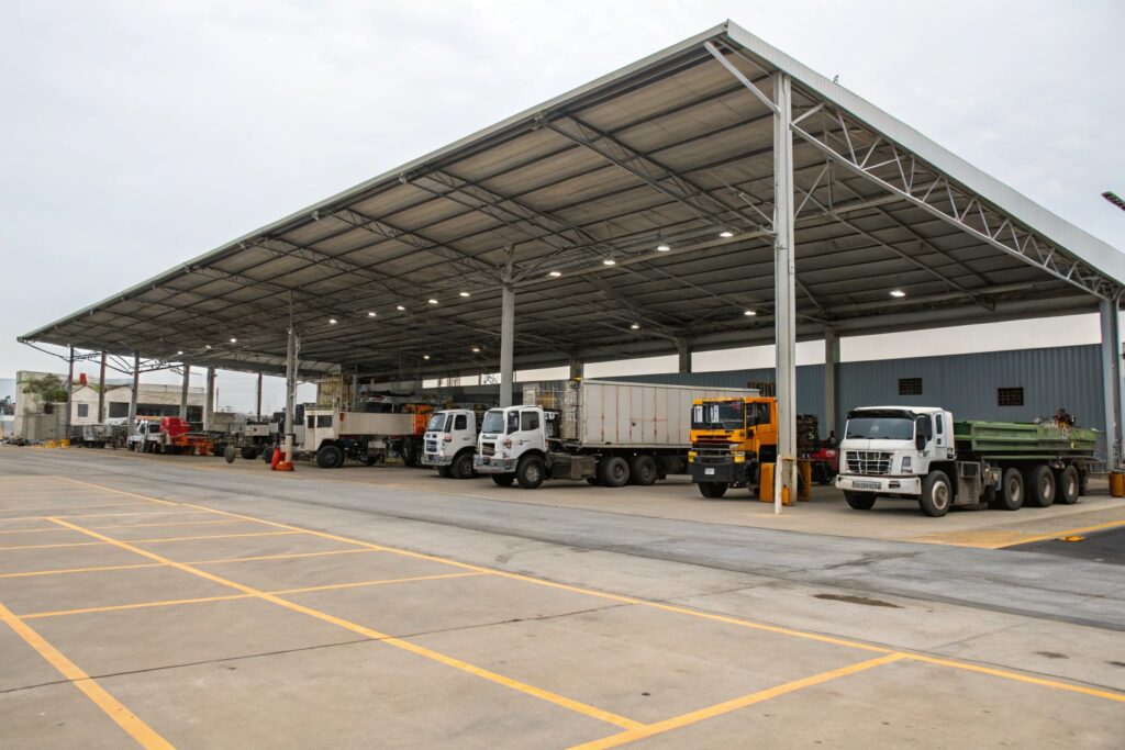 Large industrial carport in Vincent sheltering multiple commercial trucks