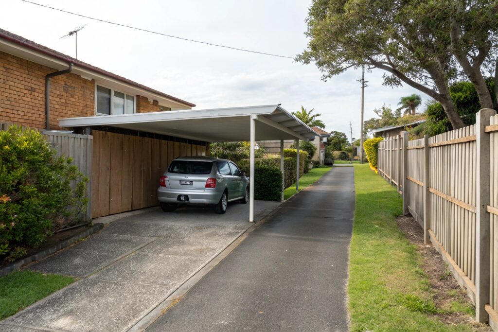 Single carport on a narrow suburban block preserving side driveway access in Mundingburra